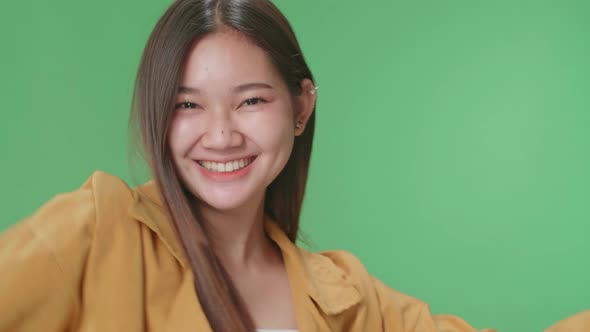 Close Up Of The Smiling Asian Woman Dancing On Green Screen In A Green Screen Studio