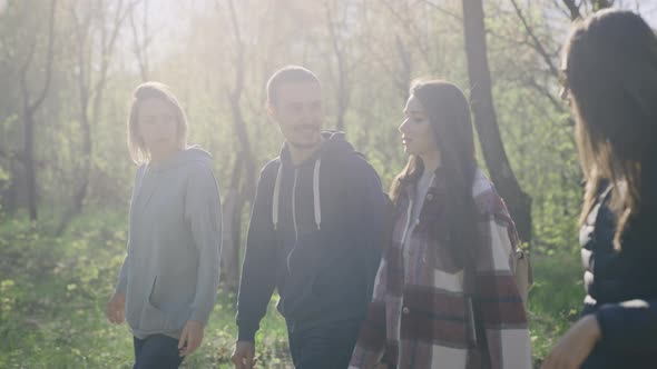 A Group of Young Successful and Beautiful People are Walking in the Park