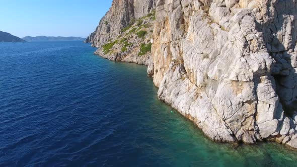 Rocky Steep Wall Cliff by the Seashore in Untouched Sea