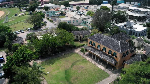 Bird's eye view of a car, trees and roof of George Washington House in Bridgetown, Barbados