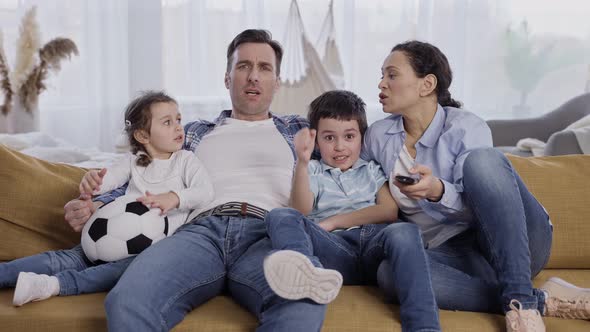 Friendly Family with Kids Watching TV at Home