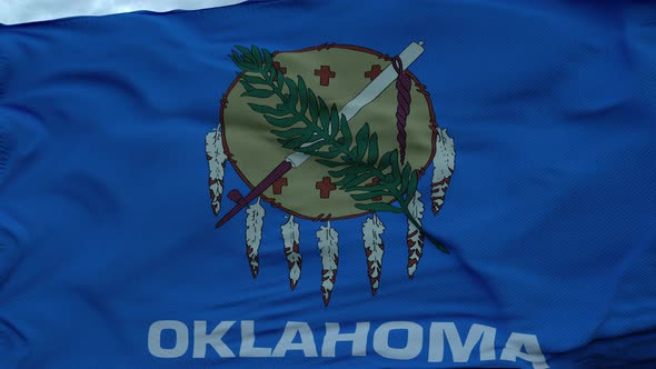 Flag of Oklahoma Waving in the Wind Against Deep Beautiful Clouds Sky