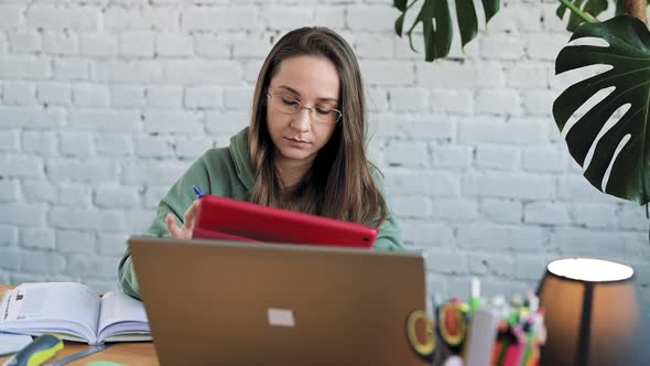 Serious White Girl Student in Glasses Typing on Laptop Preparing Course Work