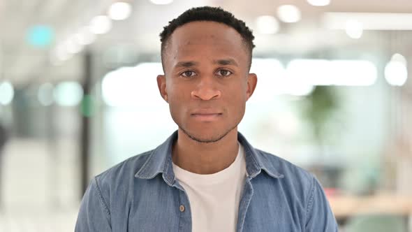 Portrait of Serious Casual African Man Looking at Camera