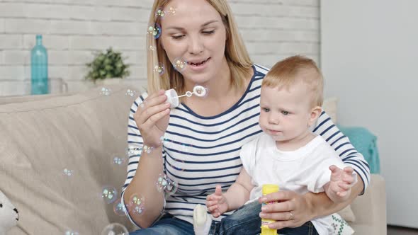 Mother Blowing Bubbles for Baby alt