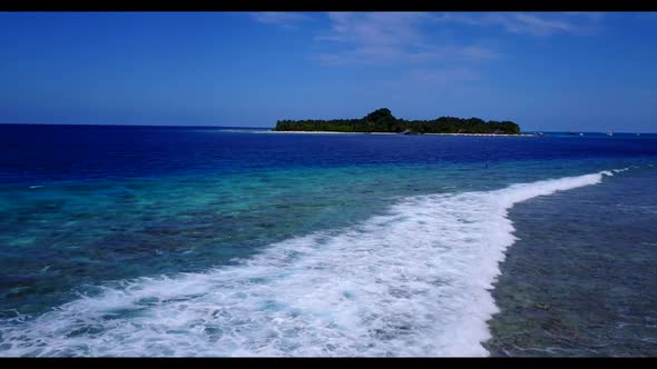 Aerial panorama of tranquil resort beach voyage by shallow ocean with clean sandy background of adve