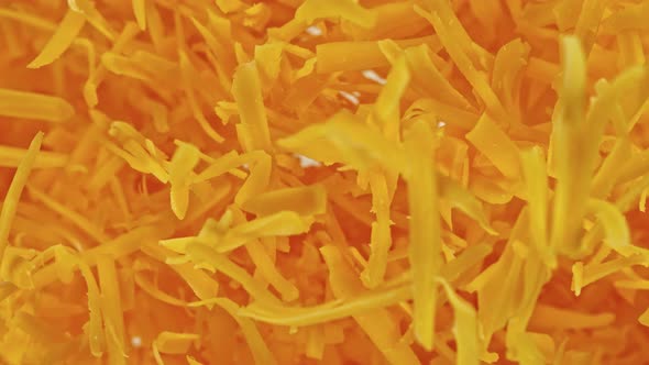 Super Slow Motion Detail Shot of Flying Grated Cheddar Cheese at 1000 Fps