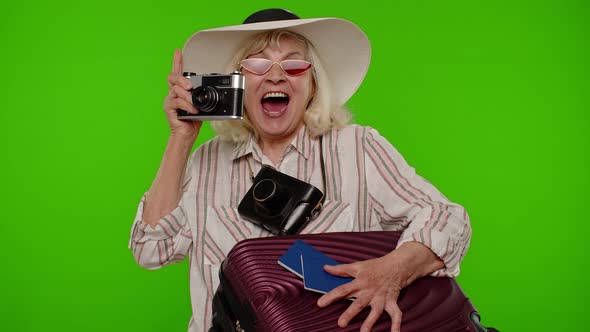 Mature Woman Photographer Traveler in Sunglasses Taking Picture Photos on Retro Camera Chroma Key