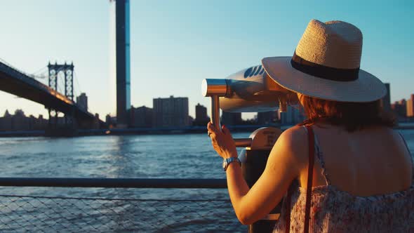 Young girl with binoculars at the view point