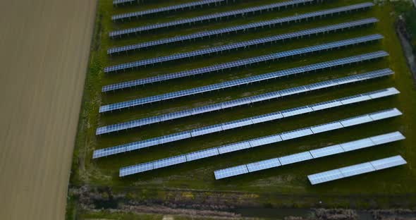 Wide Blue Photovoltaic Panel Rows on Green Grass Lawn