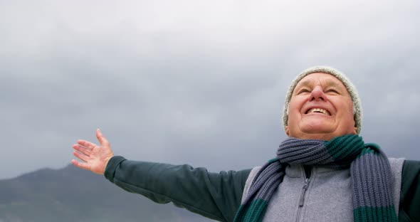 Happy senior man standing on the beach