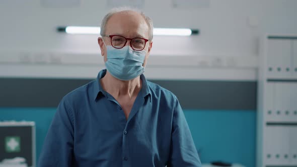 Portrait of Senior Patient Attending Medical Consultation in Cabinet