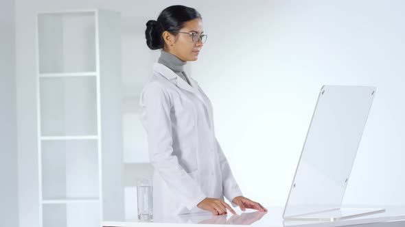 Female Doctor Working on Invisible Futuristic Computer