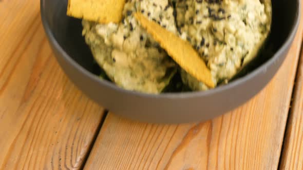 Delicious Raw Food Snack with Green Leaves and Yellow Crisps