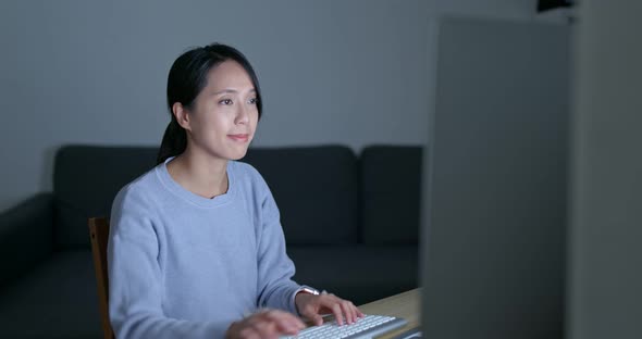 Woman work on computer at night