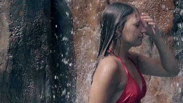 Lady in Red Bikini Under Waterfall at Stones Slow Motion
