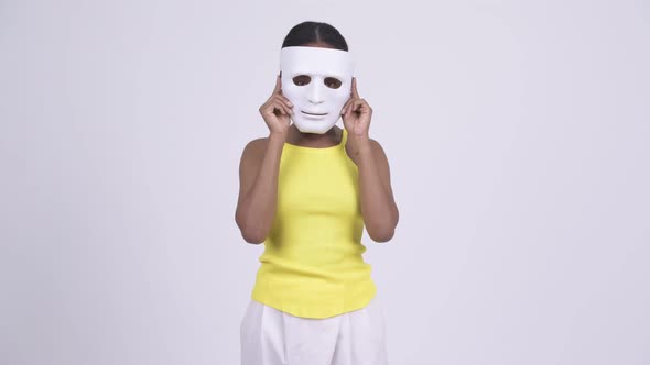 Happy Young African Woman Removing White Mask