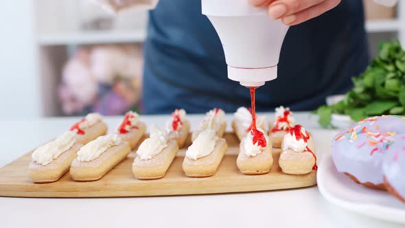 Professional Baker Woman Arms Applying Appetizing Sweety Sause on Pastry