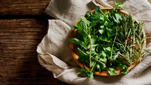 Fresh herbs in wooden plate 4k