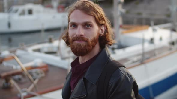 Portrait of Ginger Man Standing near Boat