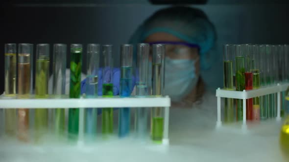 Researcher Opening Refrigerator and Dripping Oily Substance in Yellow Liquid