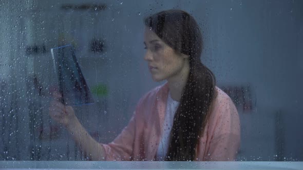 Frustrated Woman Looking on Lungs X-Ray on Rainy Day