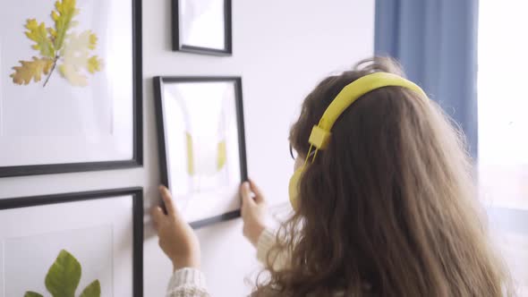 Joyful Lady with Long Loose Curly Hair Listens to Music