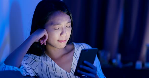 Woman use of mobile phone at night