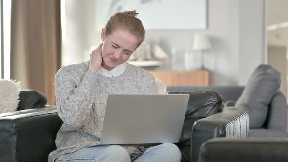 Young Woman with Laptop Having Neck Pain at Home 