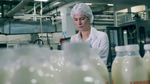 Female Employee Is Inspecting Dairy-production Process at a Food Factory