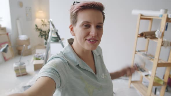 Woman Talking on Online Call while Renovating Home