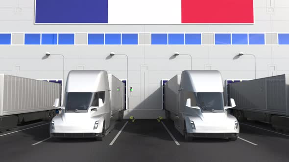 Electric Trucks at Warehouse Dock with Flag of FRANCE alt