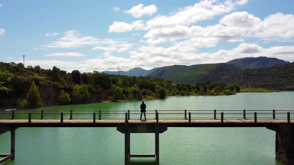 Man Standing In The Bridge Over The Reservoir1