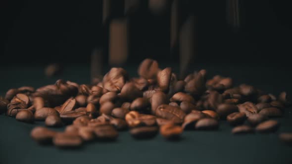 Closeup of Mocha Coffee Beans Fall and Bounce on the Table