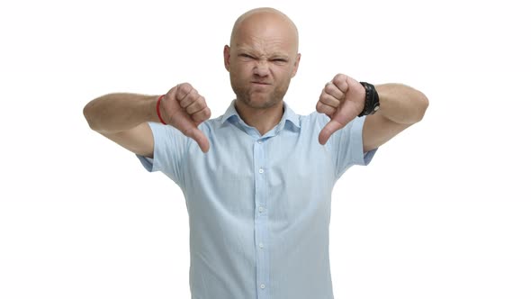 Middleaged of Bald Bearded Man in Blue Shirt Telling No Shaking Head and Grimacing Showing