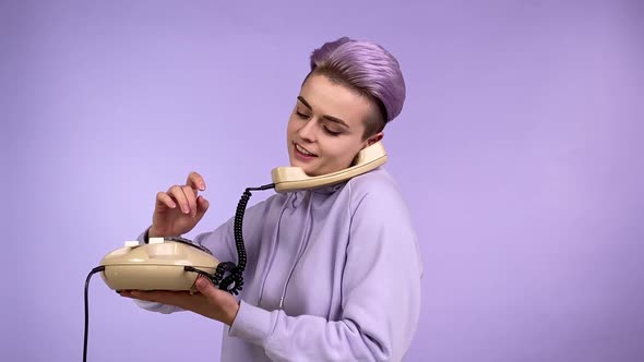 Modern Young Person Talking By Using Retro Corded Phone Isolated