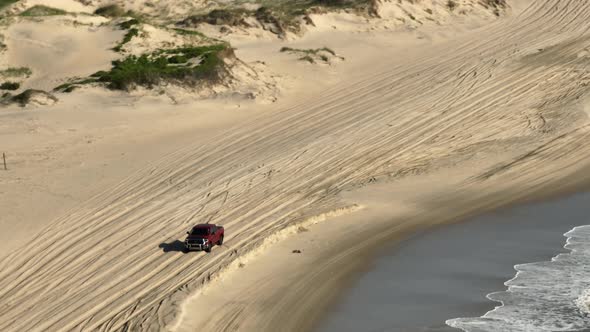 Aerial Video Red Pick Up Truck Driving On Beach Sand At High Speed