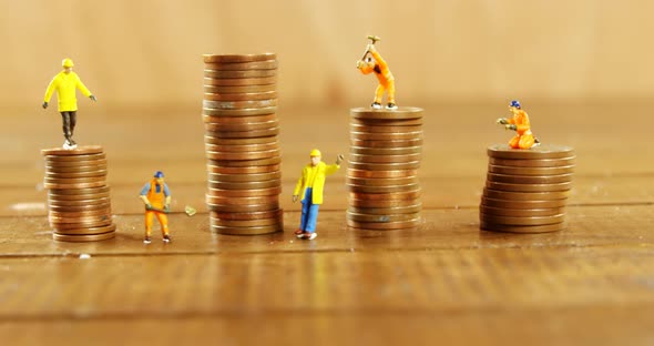 Close-up of figurine with stack of coins