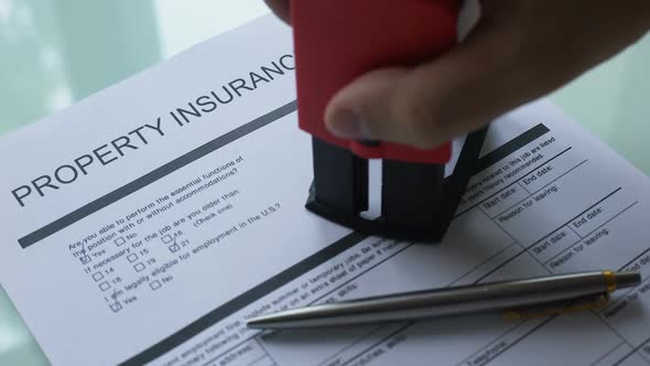 Pending Property Insurance Policy, Hand Stamping Seal on Official Paper, Closeup