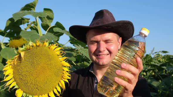 Sunflower Oil in the Hands of a Male Farmer on the Field