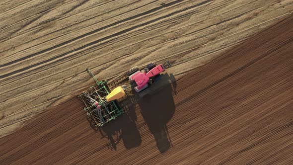 Tractor Planting Seeds Of Grain Crops In Agricultural Field Aerial Top View