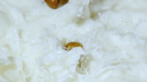 Hazelnuts being dropped into milk, Ultra Slow Motion