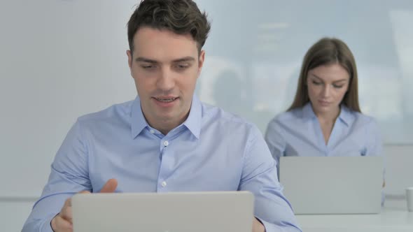 Excited Businessman Celebrating Success While Working on Laptop