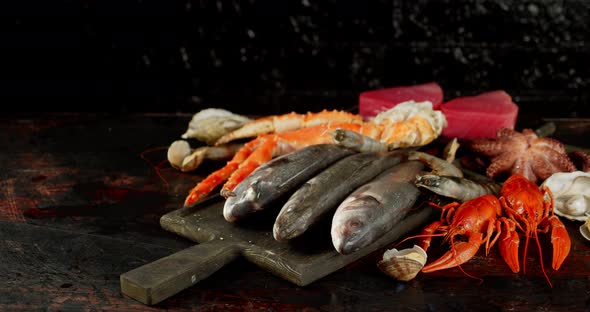 Fresh Fish and Seafood Rotate on a Cutting Board. 