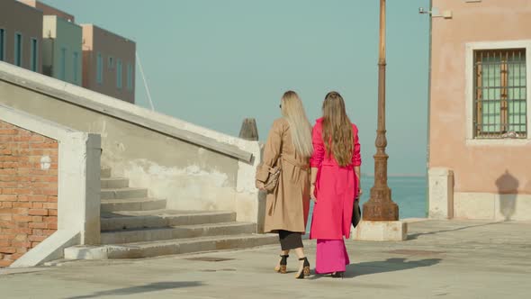 Women in Fashionable Outfits Stroll Around Venice to Bridge