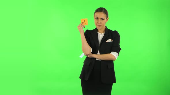 Girl Holding Paper Stick Expressing Awful Mood Then Takes Another Expressing Good Mood. Green Screen