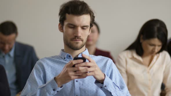 Close Up Man Using Phone During Conference Break