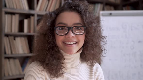 Smiling Latin Lady Teacher Wear Glasses Looking at Camera Close Up Portrait