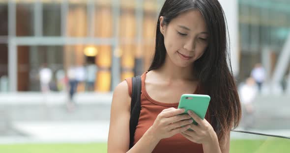 Woman use of mobile phone at outdoor 