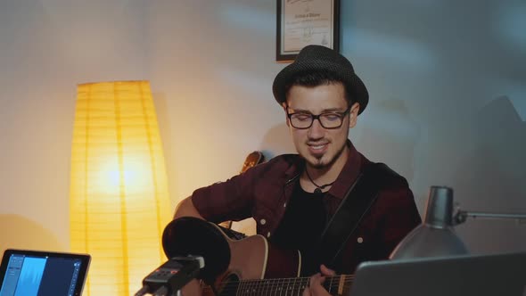 Somebody Interrupting Musician with a Remark While He Singing and Playing Guitar